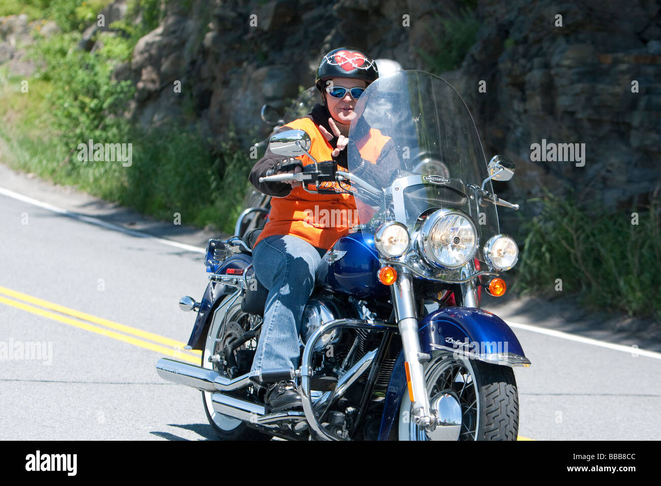 A woman rider with passenger on a Harley-Davidson motorcycle motorbike At Hawks Nest New York USA. Stock Photo