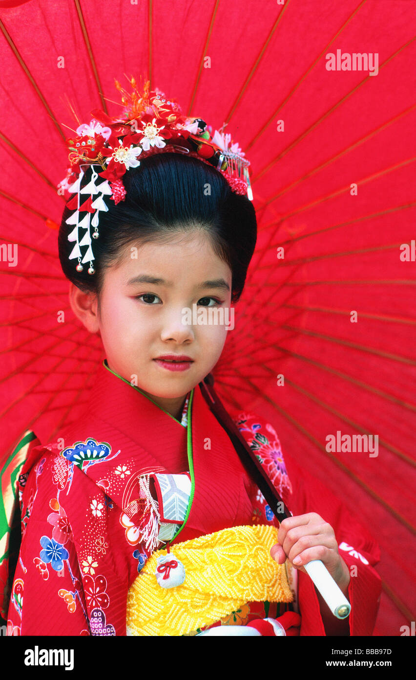 Japan, Shichi-Go-San Festival, seven year old girl with red umbrella Stock Photo