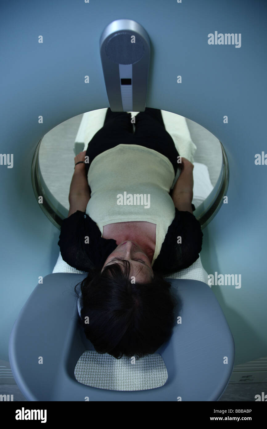 Woman lying in CTmachine waitng to be scanned Stock Photo
