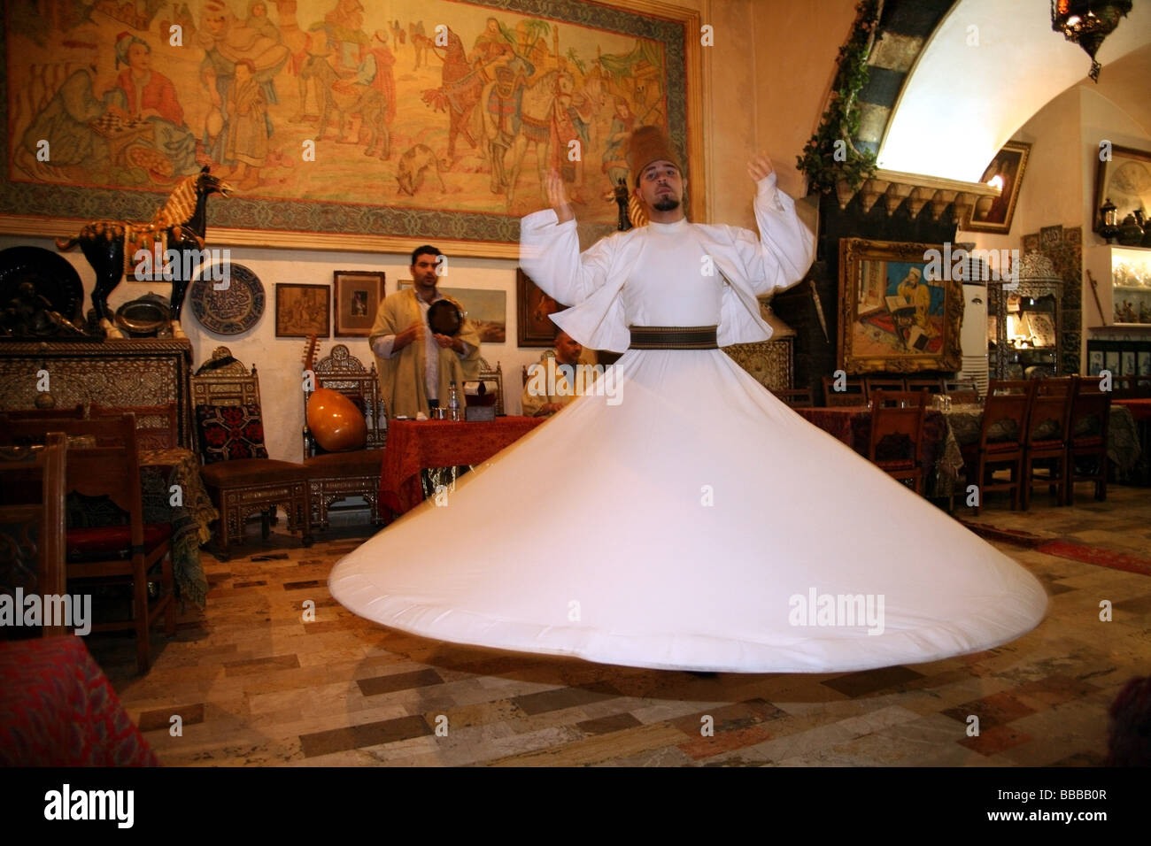 Sufi dancer or whirling dervish at a traditional restaurant Damascus Stock Photo