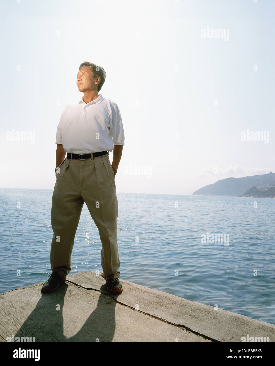 Man standing by the sea hi-res stock photography and images - Alamy