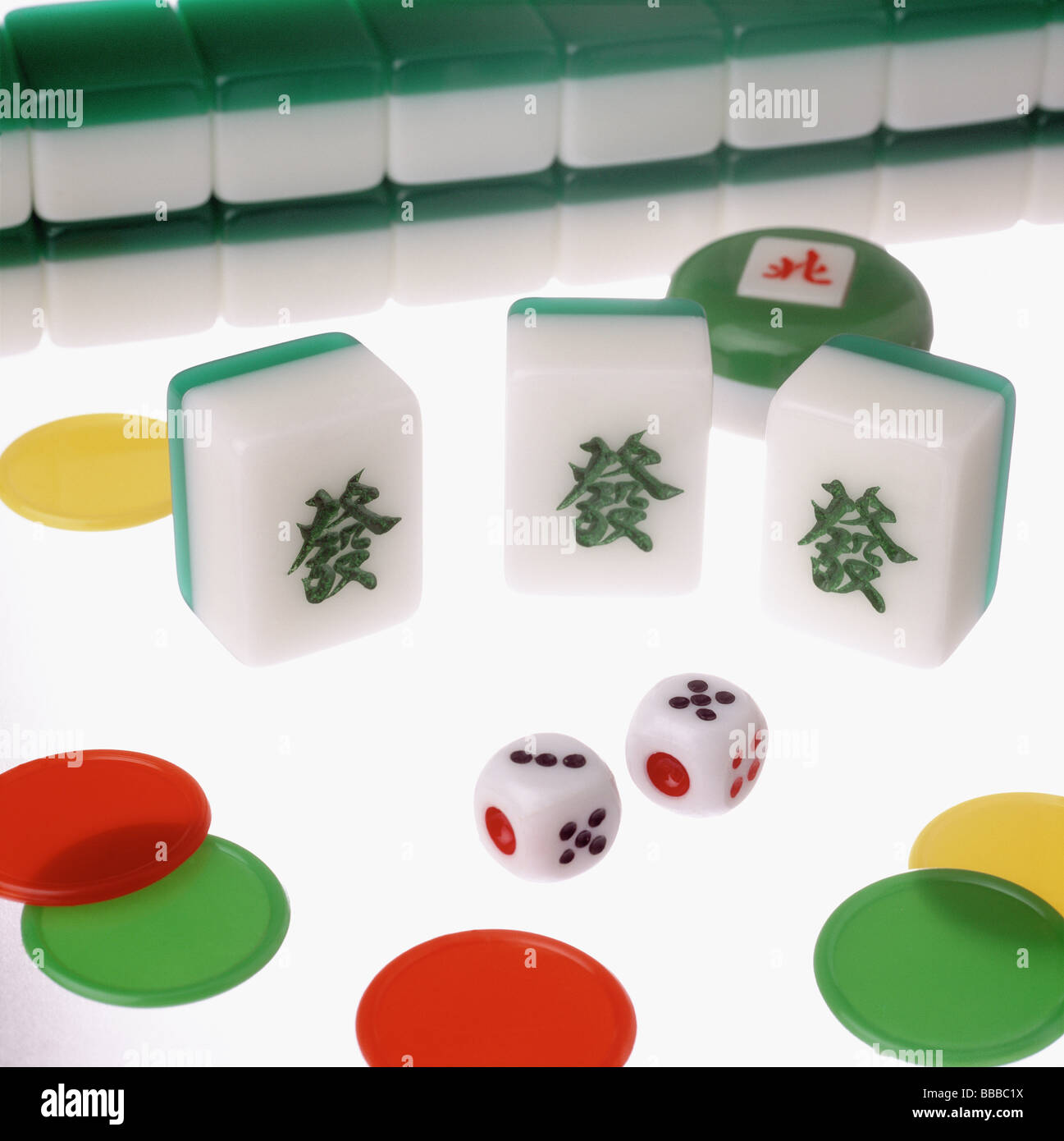 Mahjong tiles, dice and chips on a lit table Stock Photo - Alamy