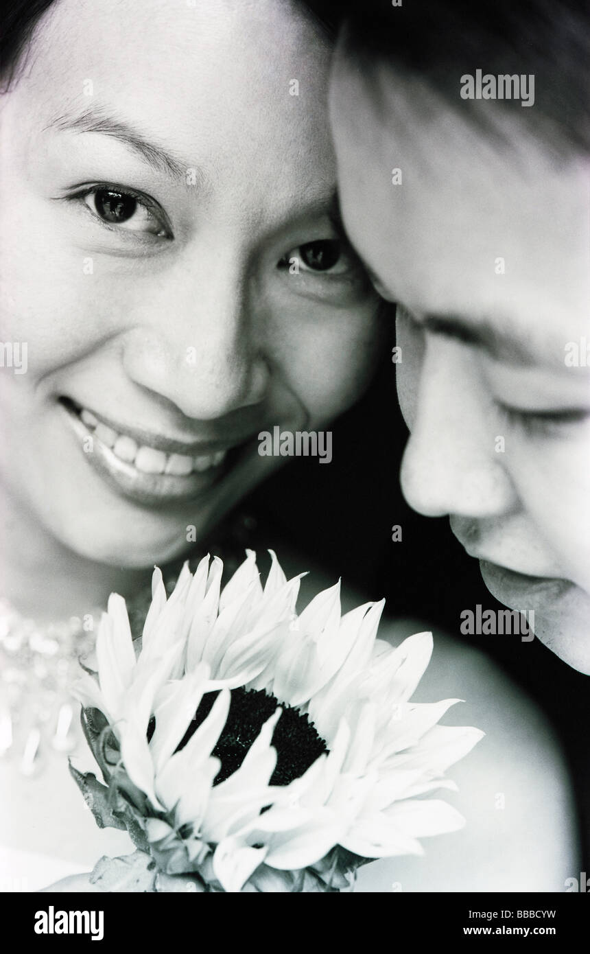 Happy couple holding flower hi-res stock photography and images - Alamy