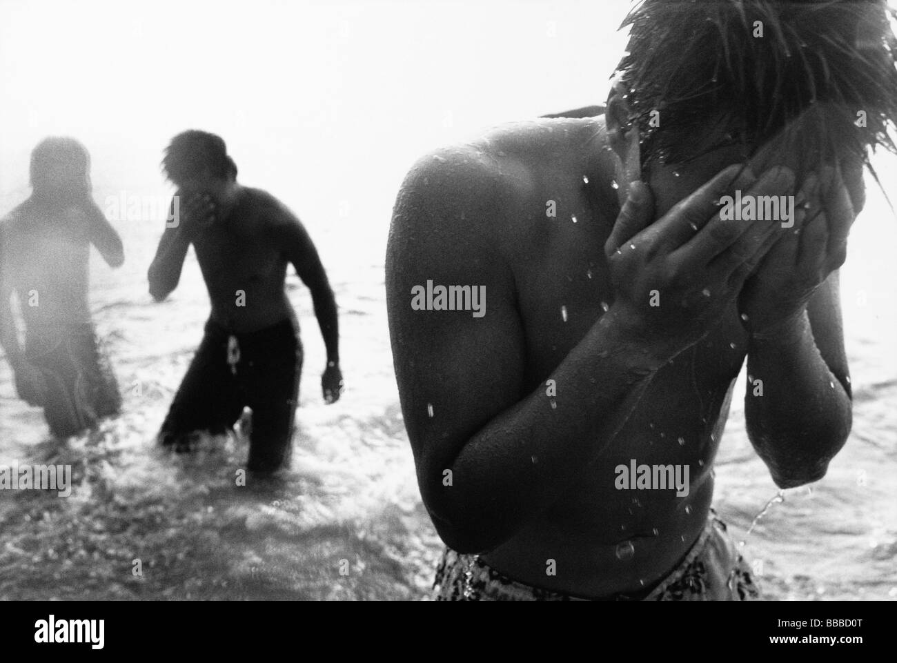 Teenagers wading in the ocean Stock Photo Alamy