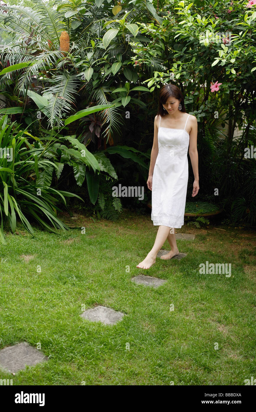 Woman walking barefoot grass garden hi-res stock photography and images ...