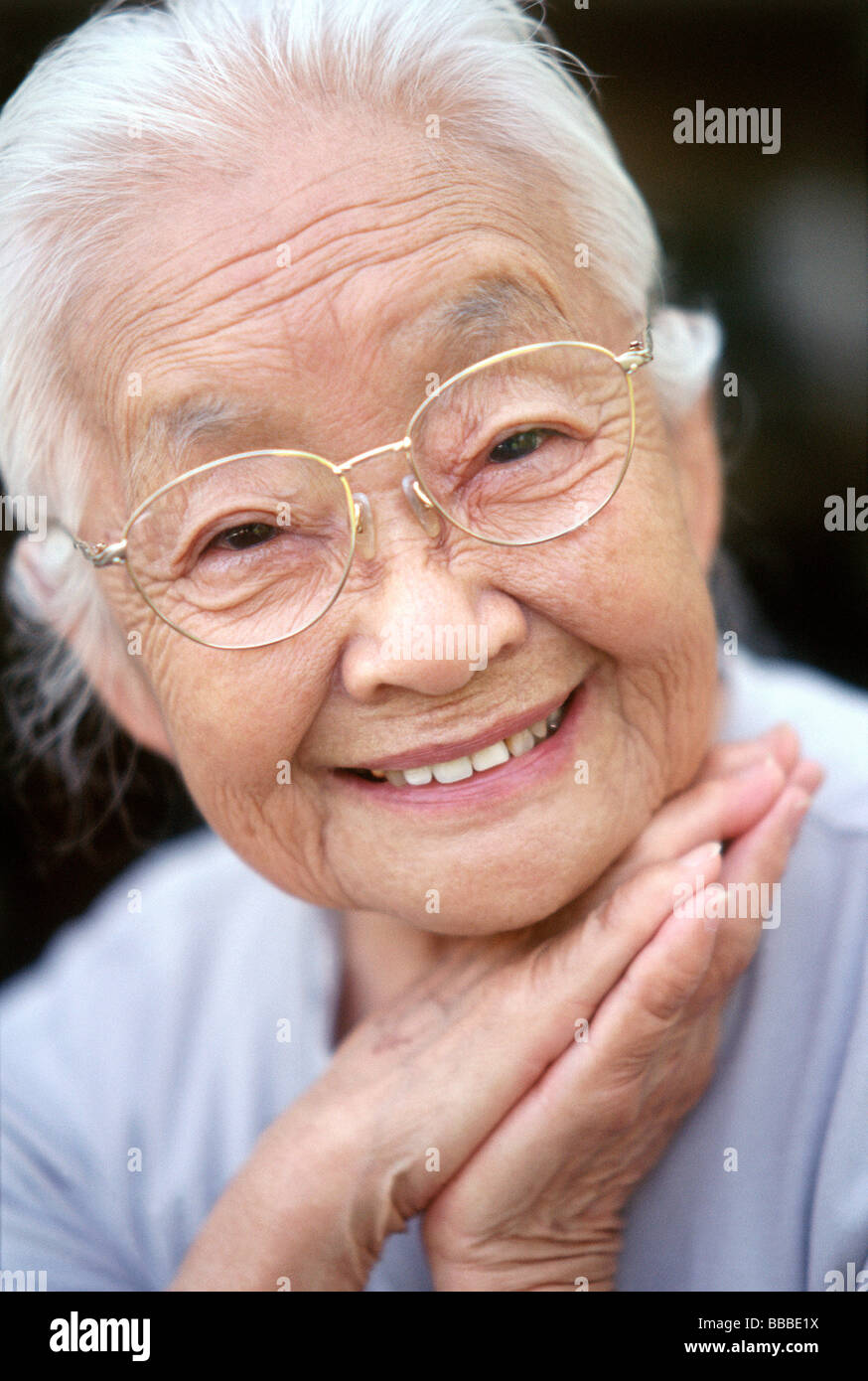 Woman resting chin on hands hi-res stock photography and images - Alamy