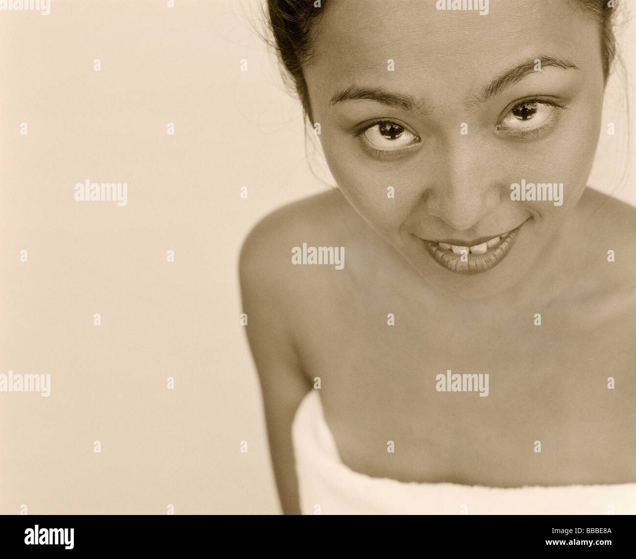 Woman wrapped in towel, portrait Stock Photo - Alamy