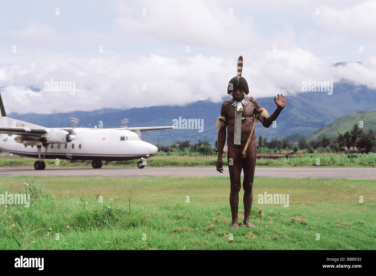 Indonesia, Irian Jaya, Dani warrior, modern plane in background Stock Photo