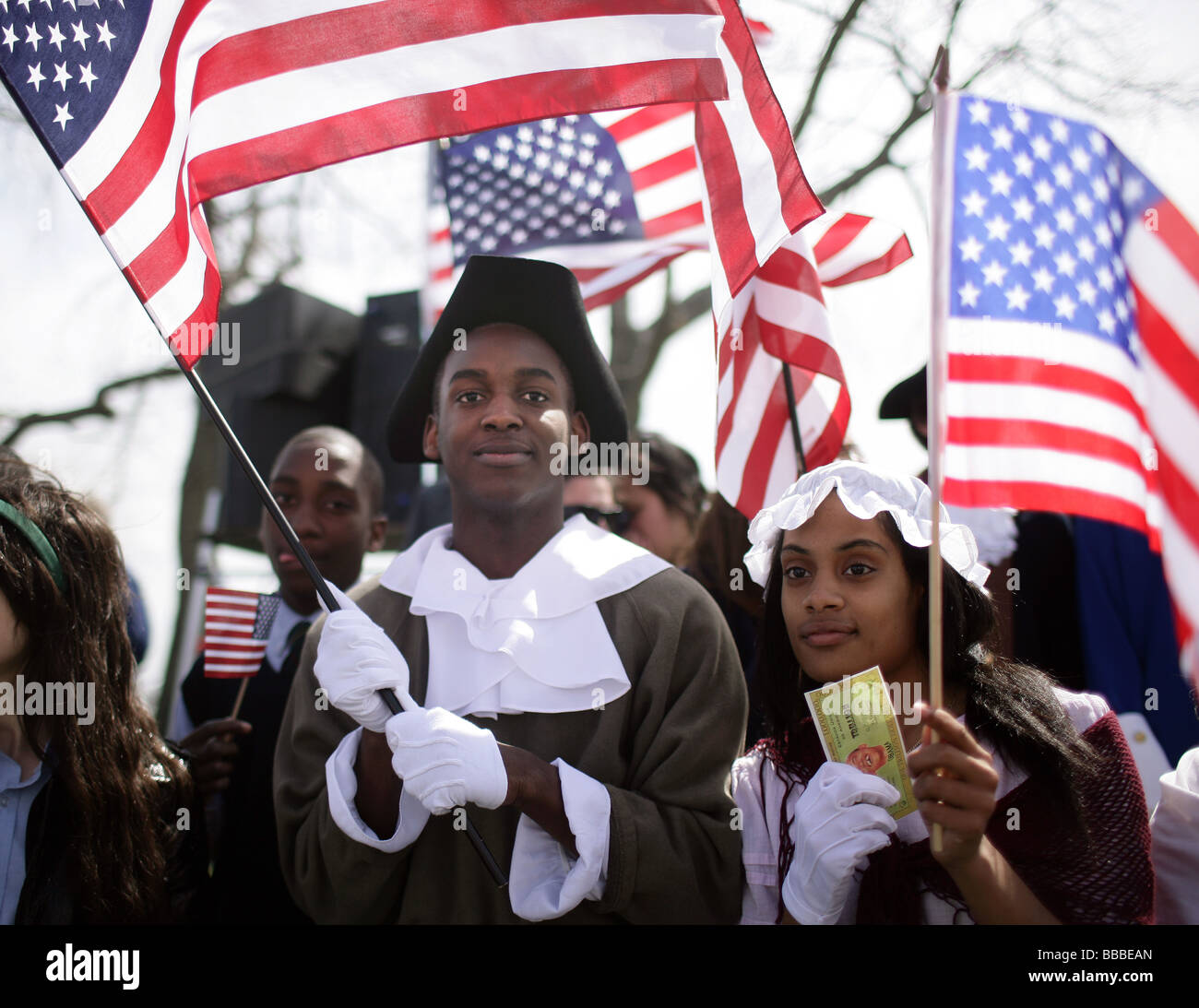 Students dressed in Colonial period costume hold American Flags during a 'Tea Party' Taxation protest in New Haven Connecticut Stock Photo