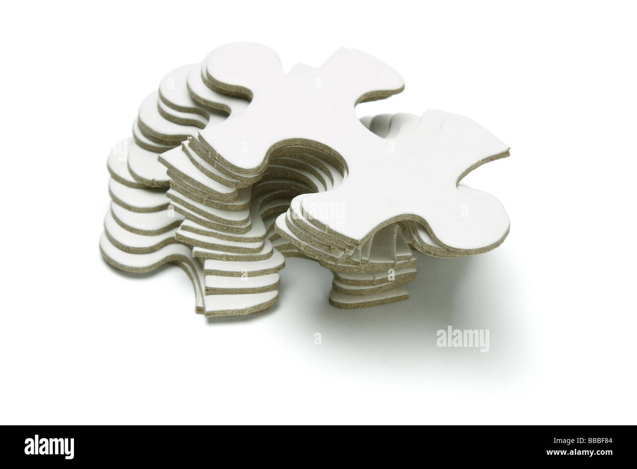 Stack of jigsaw puzzle pieces on white background Stock Photo