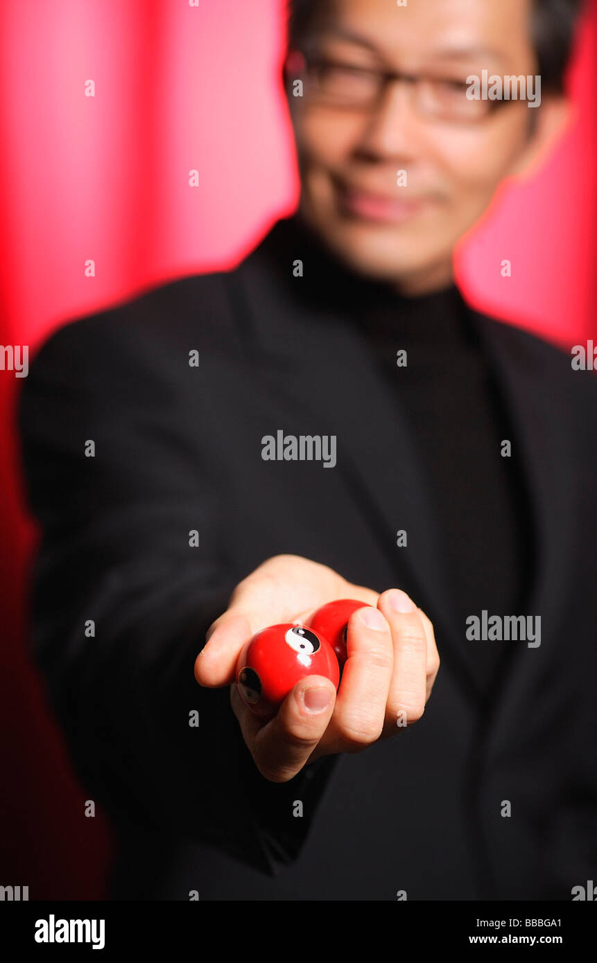 Man holding Chinese medicine balls, looking at camera Stock Photo Alamy