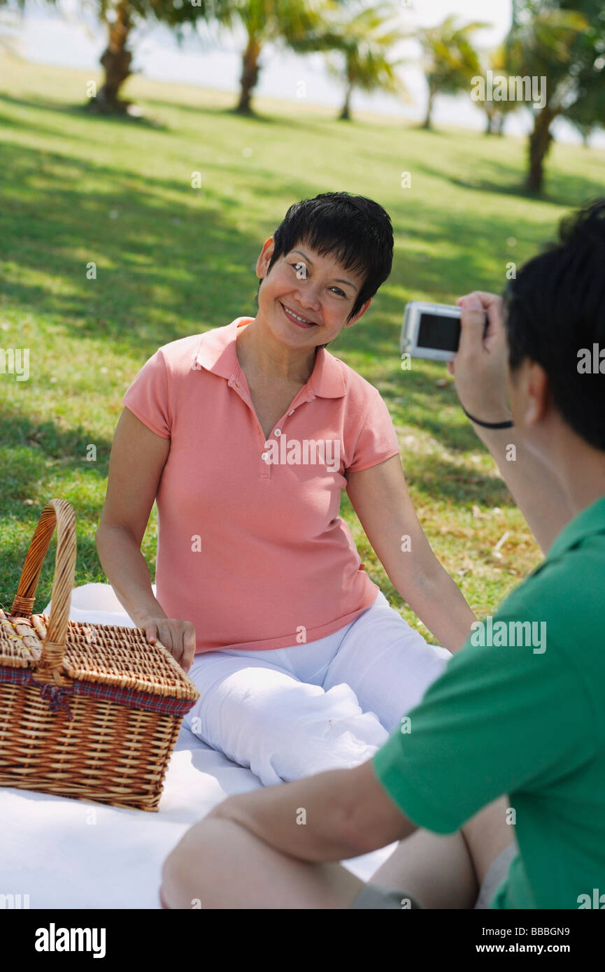 Mature Couple Having A Picnic In The Park And Taking A Picture Stock