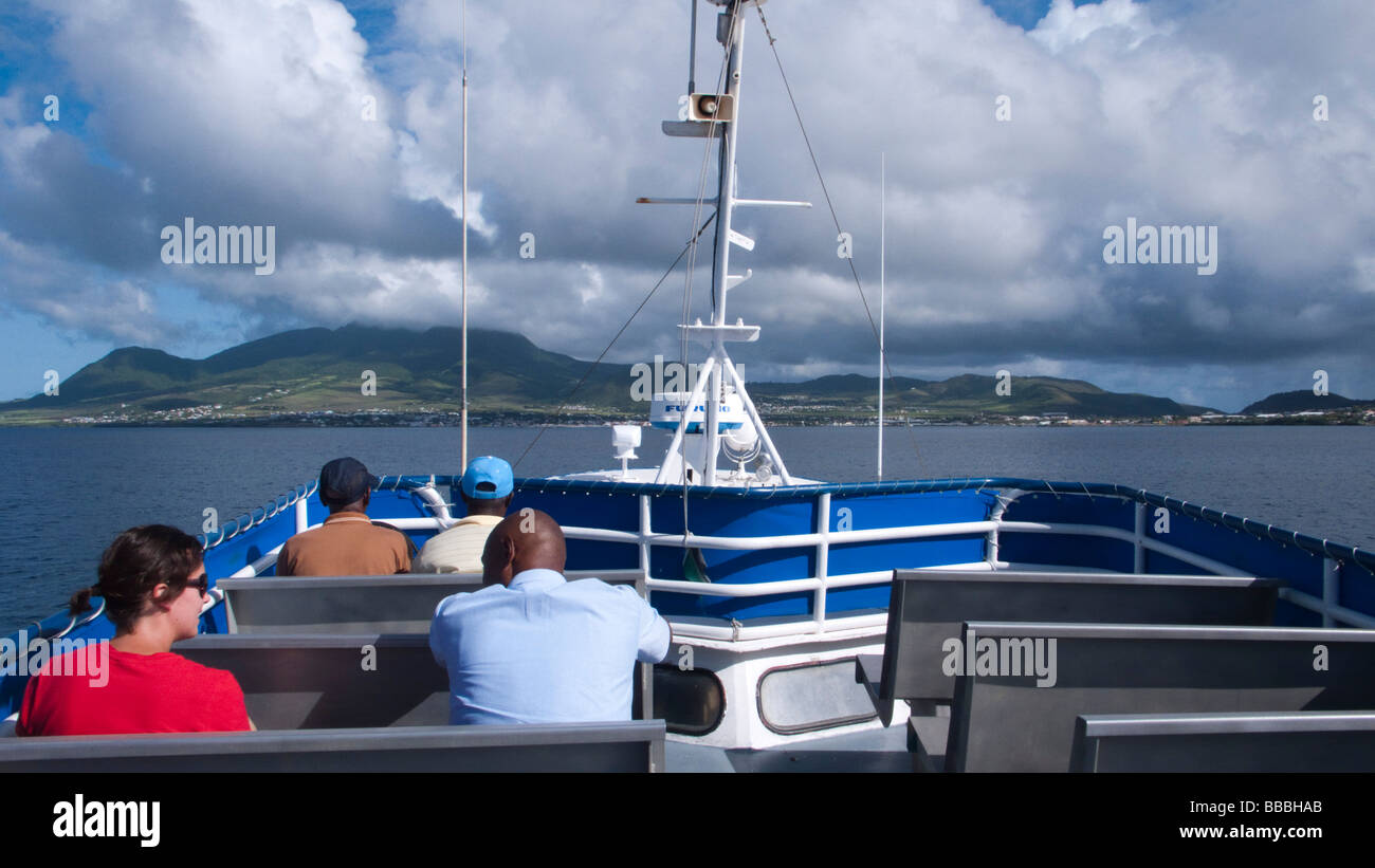 Passengers from Nevis approach Basseterre St Kitts aboard inter island ferry Voyager Cat 27 Stock Photo