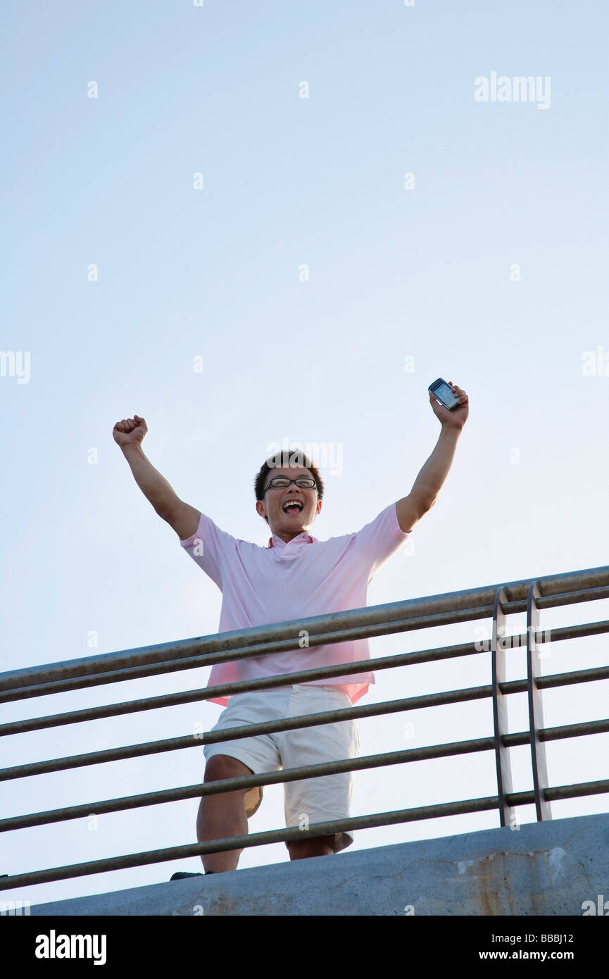 Man raising his arms in victory Stock Photo - Alamy