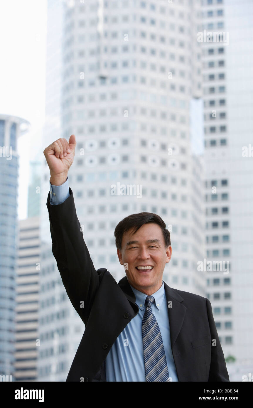 Businessman raising his arm and making a fist Stock Photo - Alamy