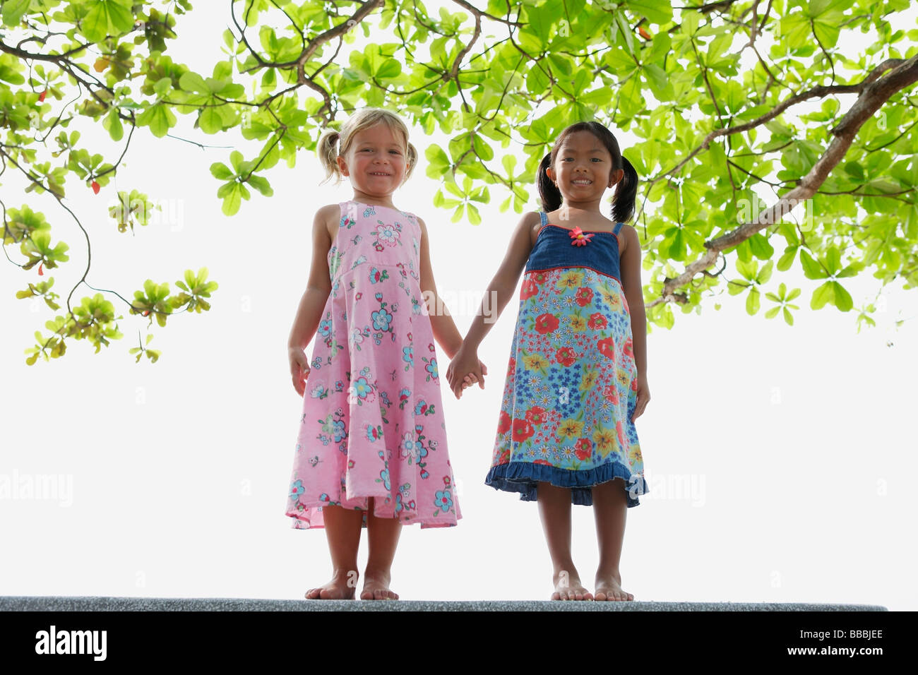 Young girls holding hands Stock Photo - Alamy
