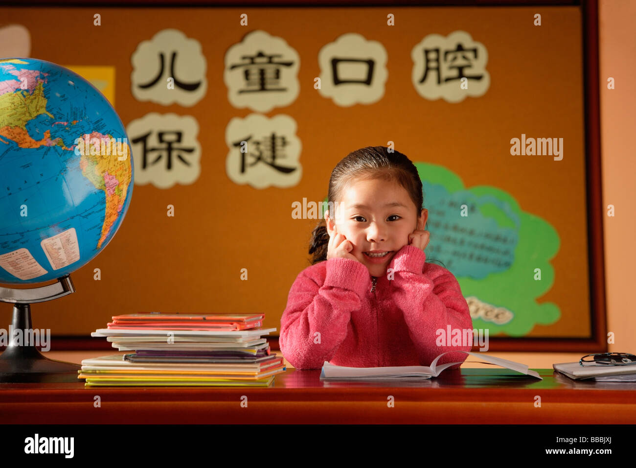 Girl sitting in class, looking at camera Stock Photo - Alamy