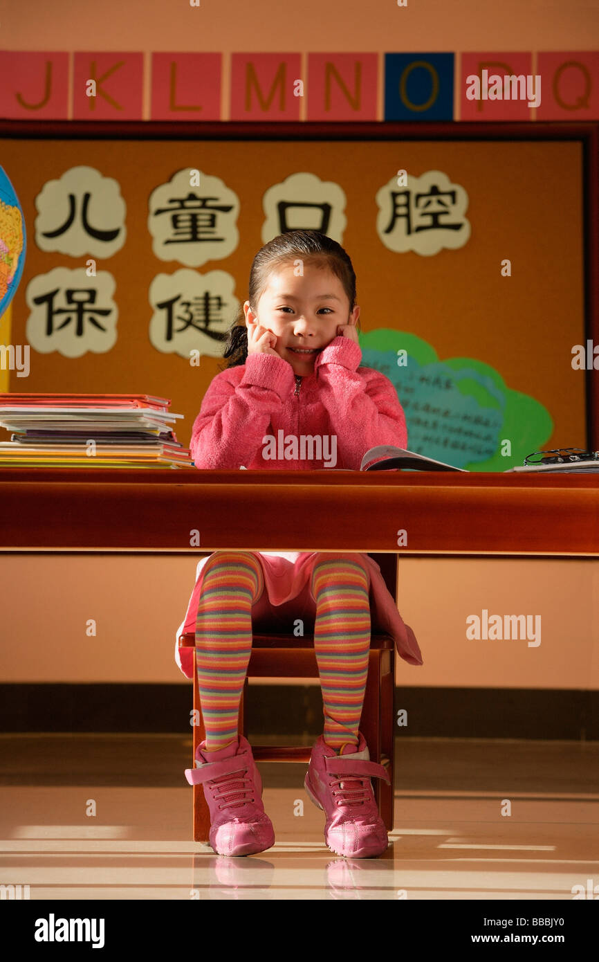 Girl sitting in class, looking at camera Stock Photo - Alamy