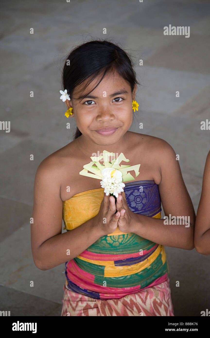 Asian girl offering flowers; Stock Photo