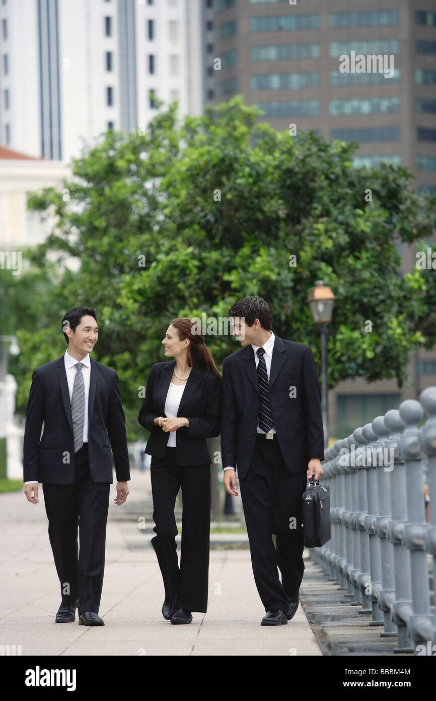 Business people walking side by side, talking Stock Photo - Alamy