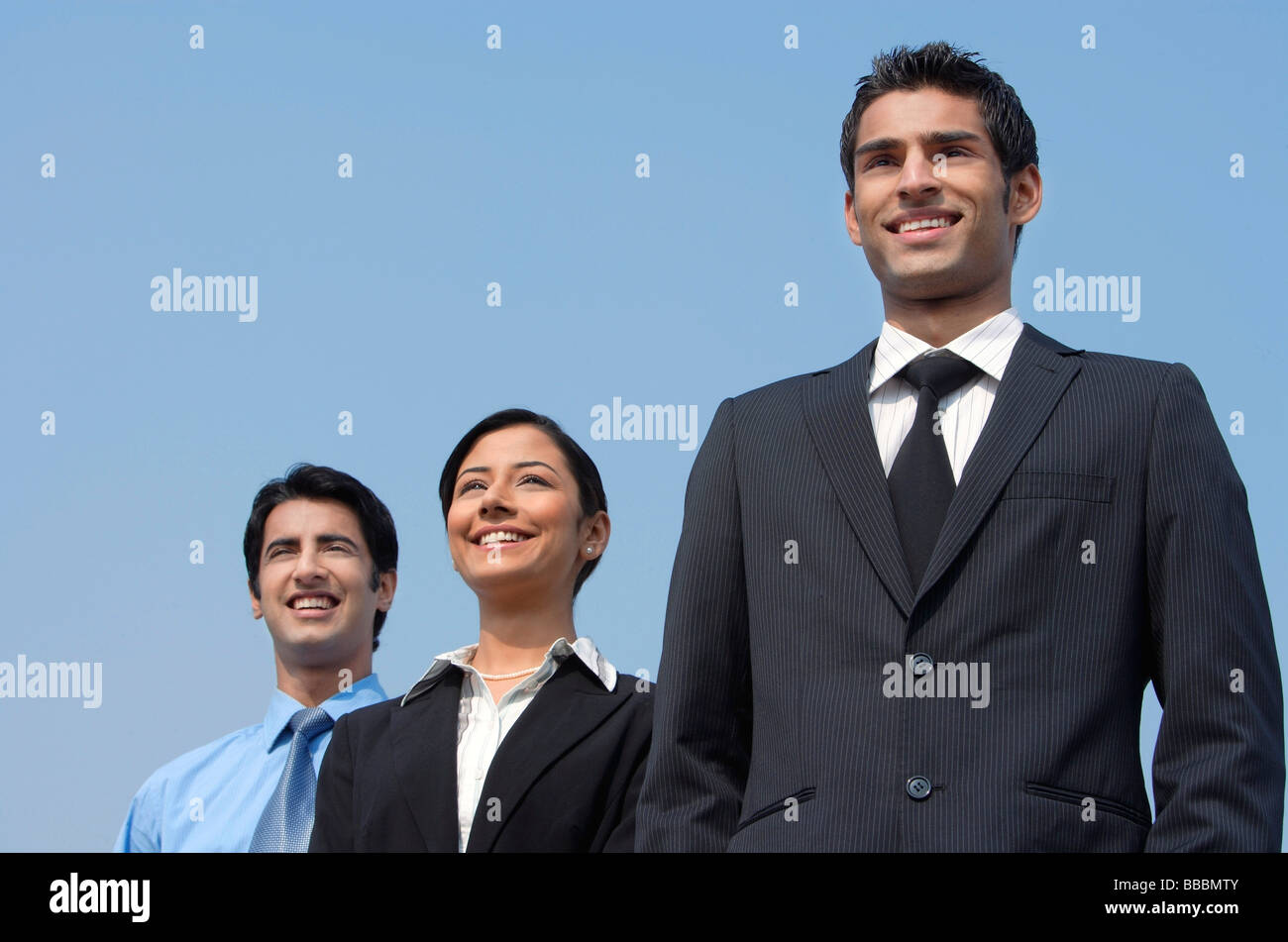 Three people standing hi-res stock photography and images - Alamy