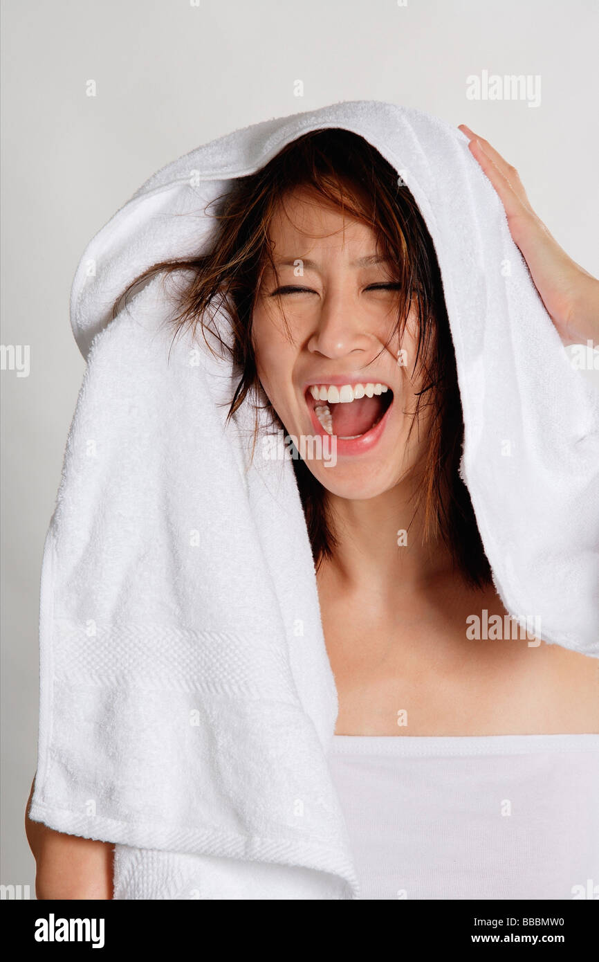Woman drying her hair with towel Stock Photo Alamy