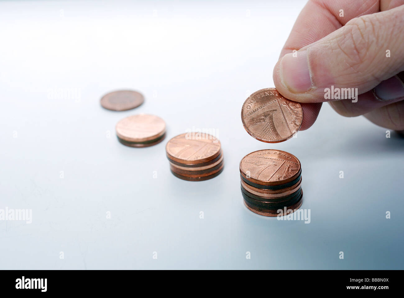 Look after your pennies and your pounds will look after themselves Small savings compounding over time Stock Photo