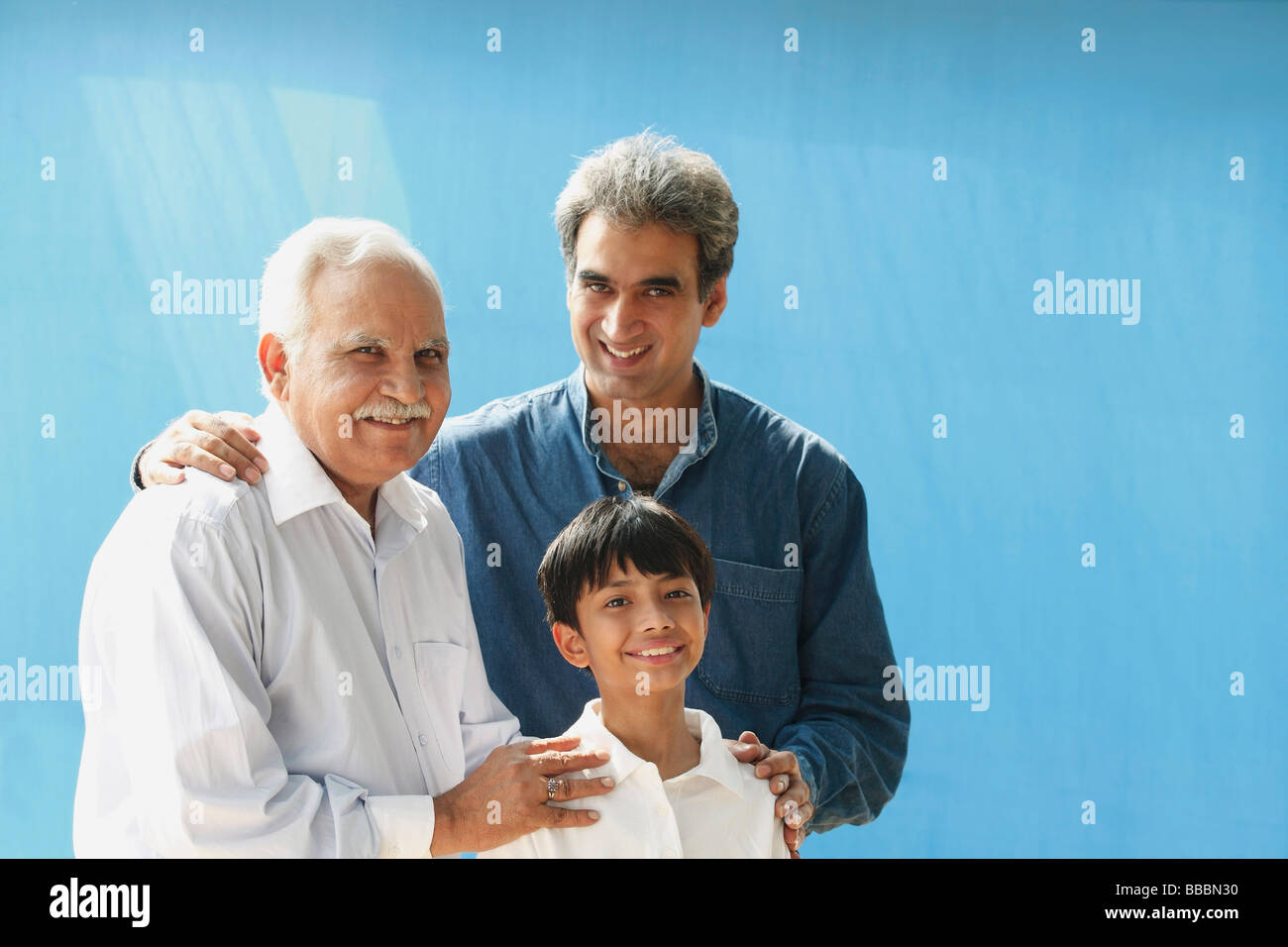 Grandfather, father, son smiling at camera Stock Photo Alamy