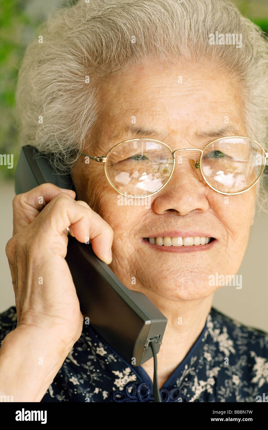 Using phone mature woman hi-res stock photography and images - Alamy