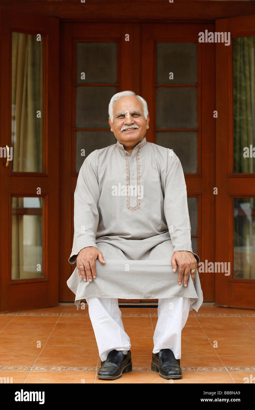 Old man sitting in chair on front porch Stock Photo - Alamy