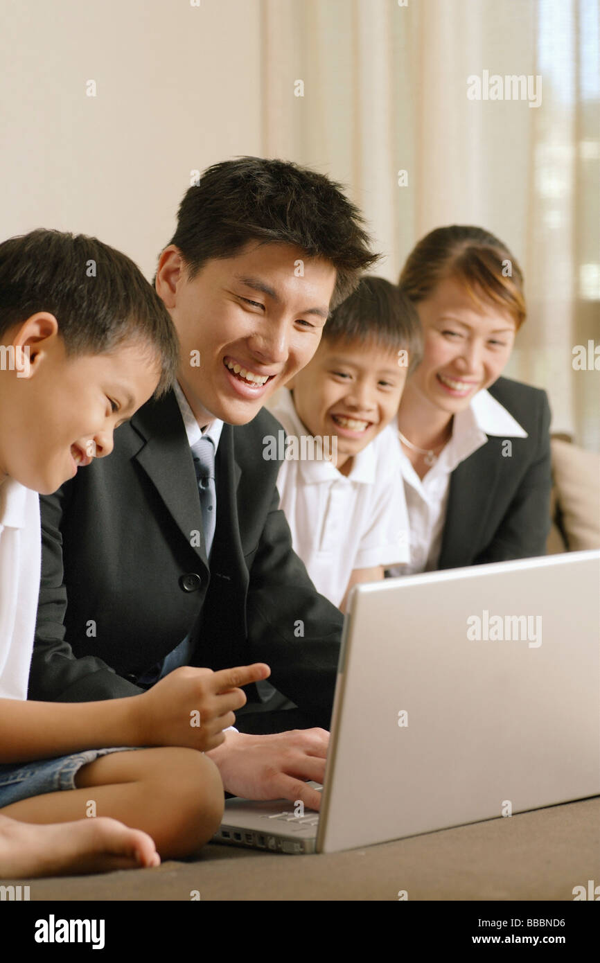 Family with two children using laptop Stock Photo - Alamy