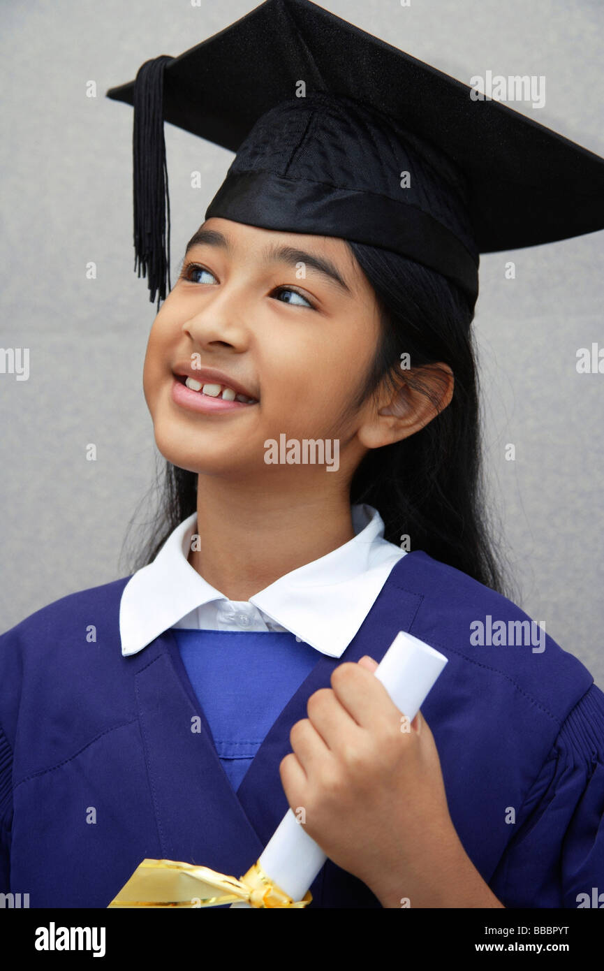 Young Indian girl wearing a graduation cap and gown Stock Photo Alamy