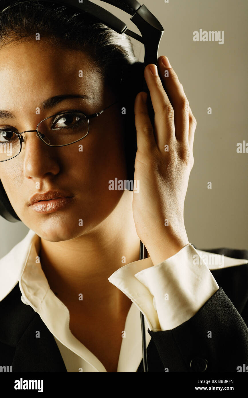 Businesswoman wearing headphones Stock Photo - Alamy