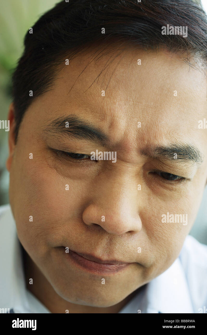 Man frowning, headshot Stock Photo