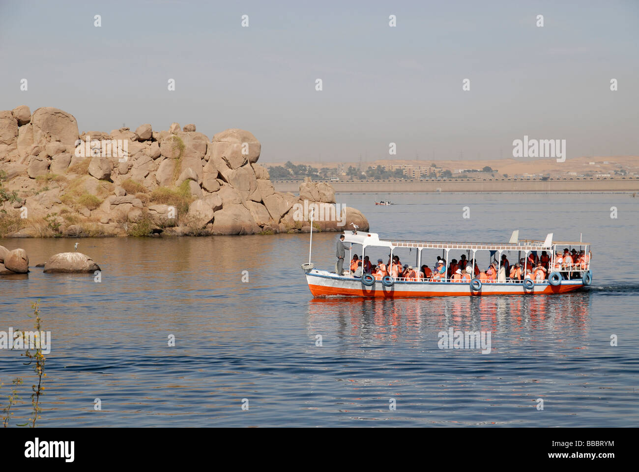 Passenger boat approaching Philae temple, Agilika Island, Aswan, River Nile, Egypt Stock Photo