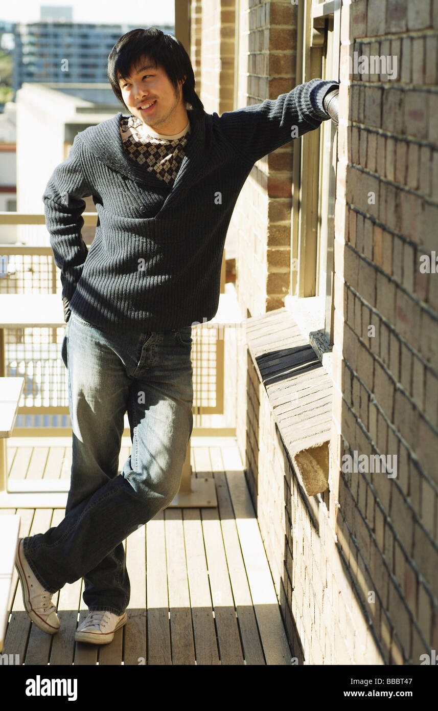 Young black man standing wall hi-res stock photography and images - Alamy