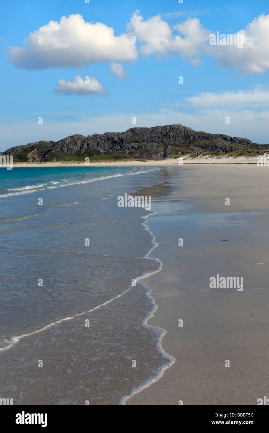 A Sandy beach with surf, blue sky and clouds on the Isle of Lewis Stock Photo