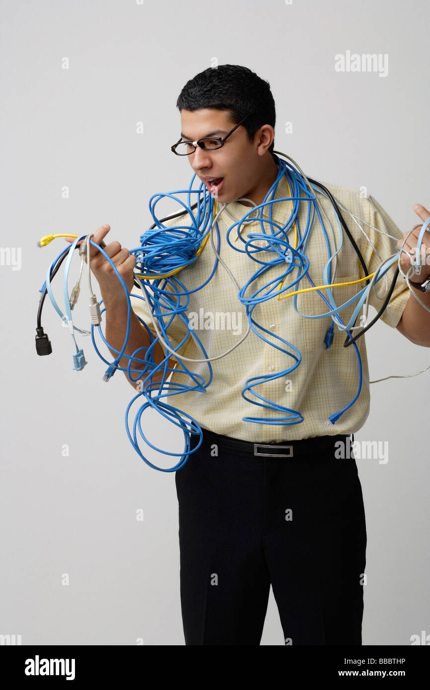 Frustrated man with computer cords and wires Stock Photo - Alamy