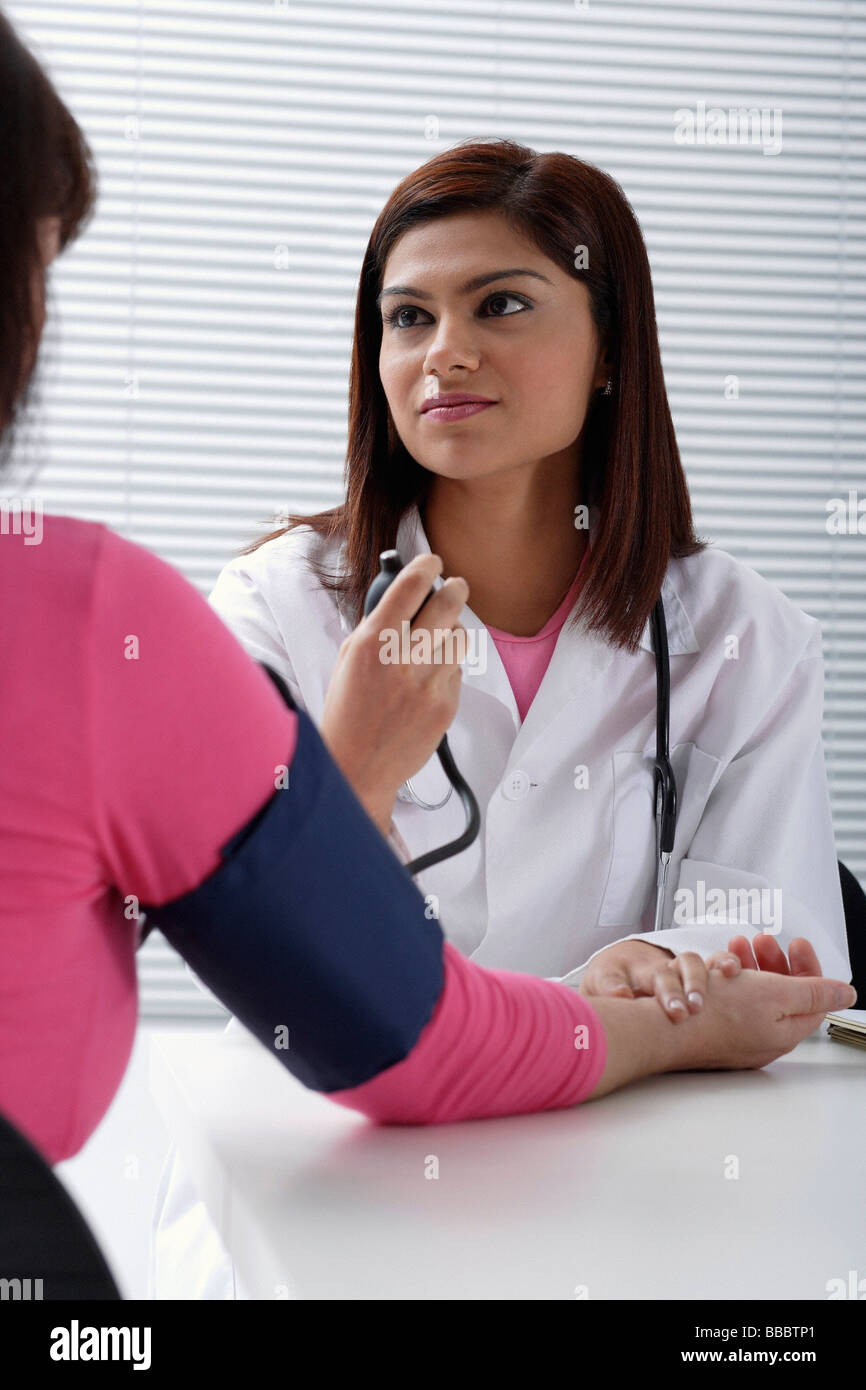 Doctor taking pulse of patient Stock Photo Alamy