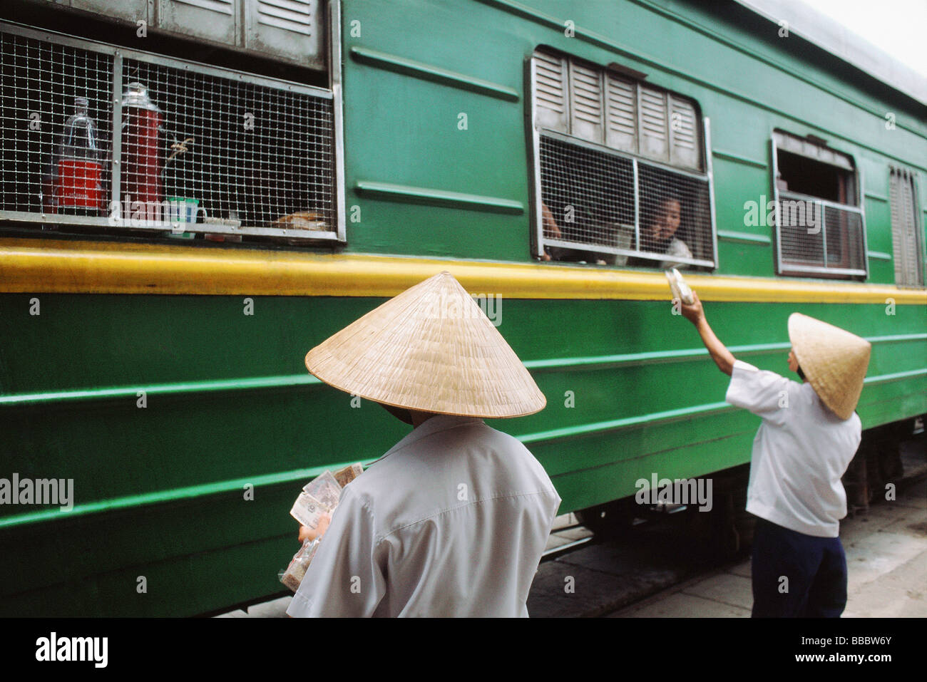 Vietnam, Locals outside the Reunification express that runs from Ho Chi Minh City (Saigon) to Hanoi Stock Photo