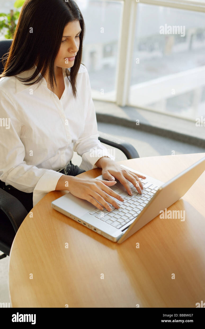 Female executive using laptop, portrait Stock Photo - Alamy