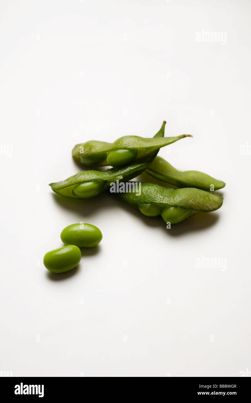 multiple green edamame beans with pea pod broken Stock Photo