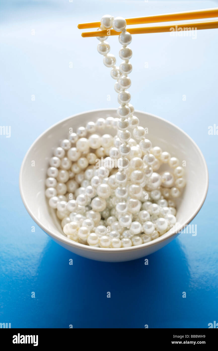 string of pearls on chopstick Stock Photo
