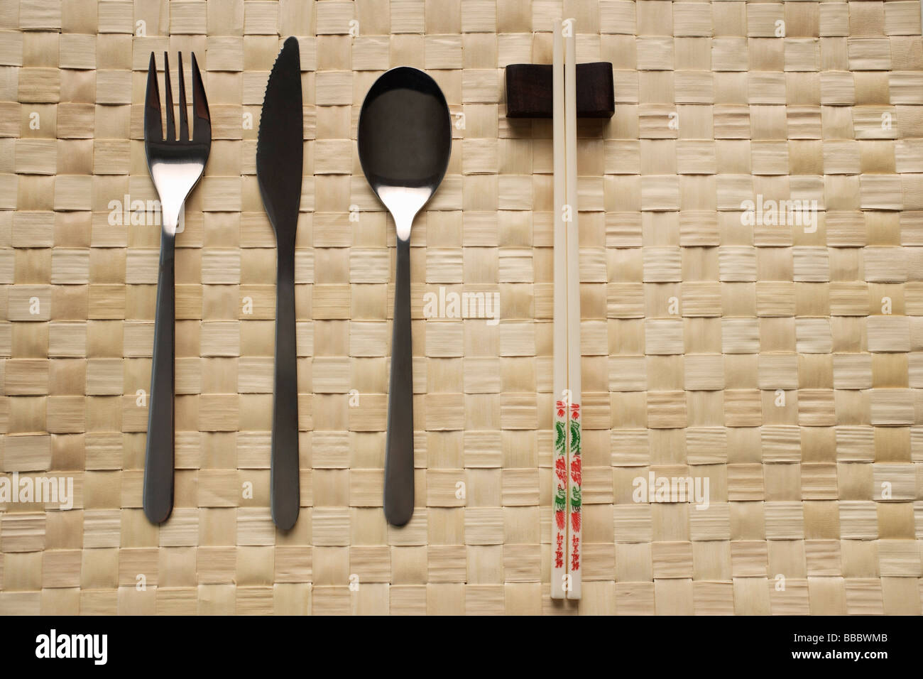 fork, knife, spoon and chopstick dinner setting Stock Photo