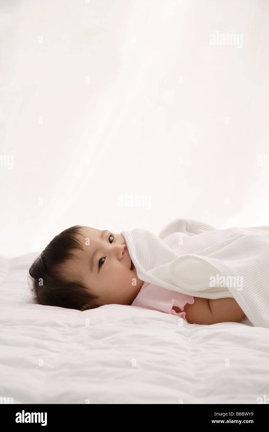 Baby girl with blanket Stock Photo Alamy