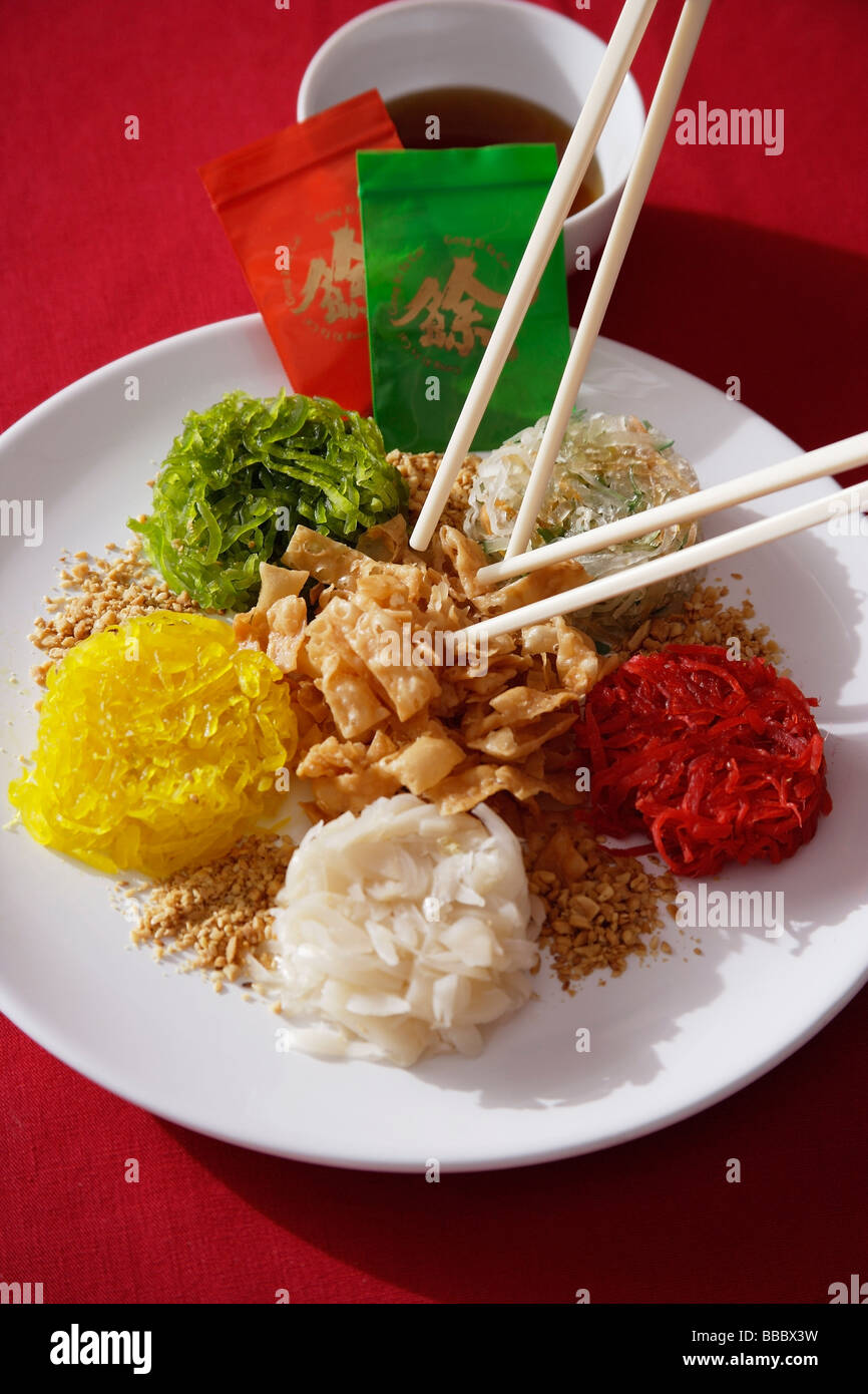 Plate of raw fish salad also known as 'Yu Sheng' or 'Lo Hei' Stock Photo