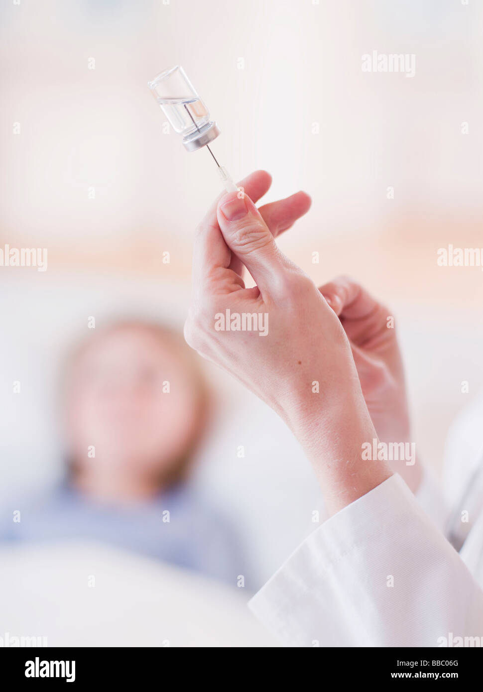 female medic's hands handling a shot Stock Photo