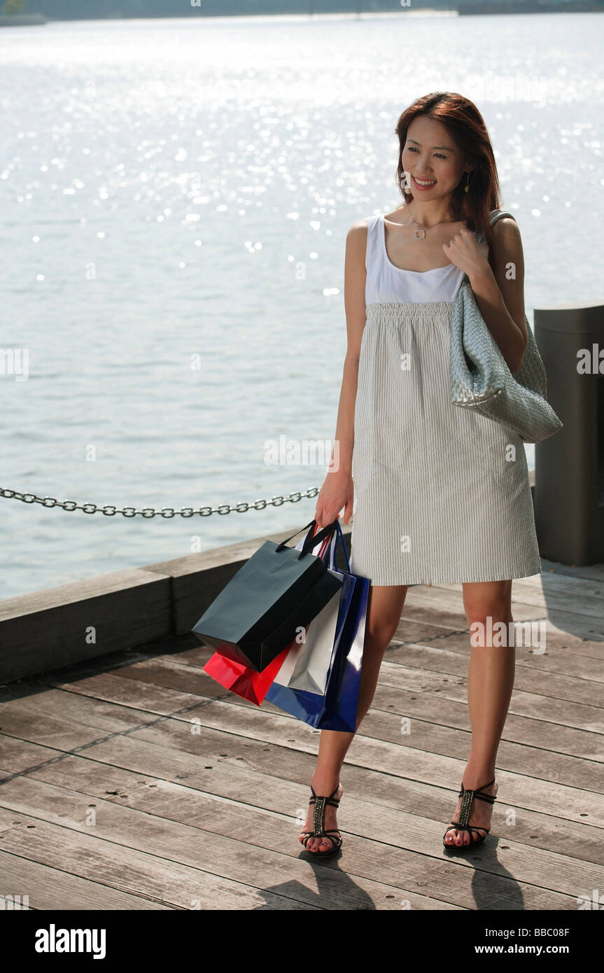 Young woman carrying shopping bags Stock Photo - Alamy