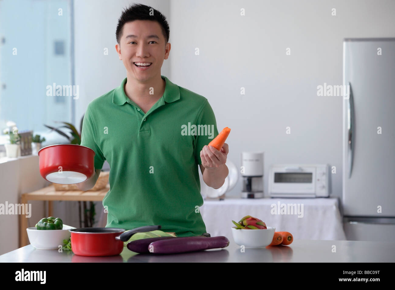 Man cooking and smiling at camera Stock Photo - Alamy