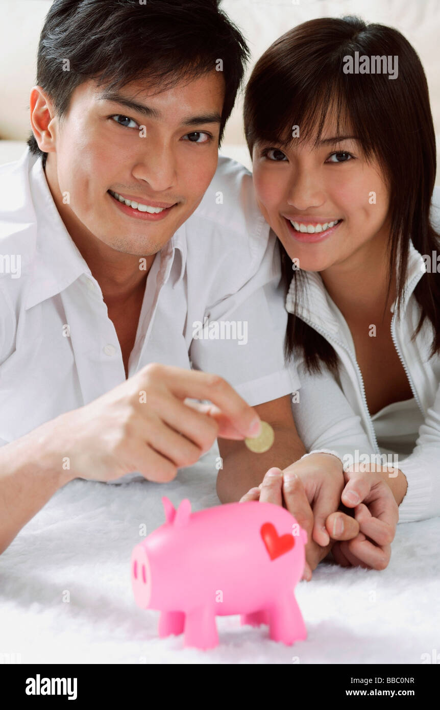Young couple with piggy bank Stock Photo - Alamy